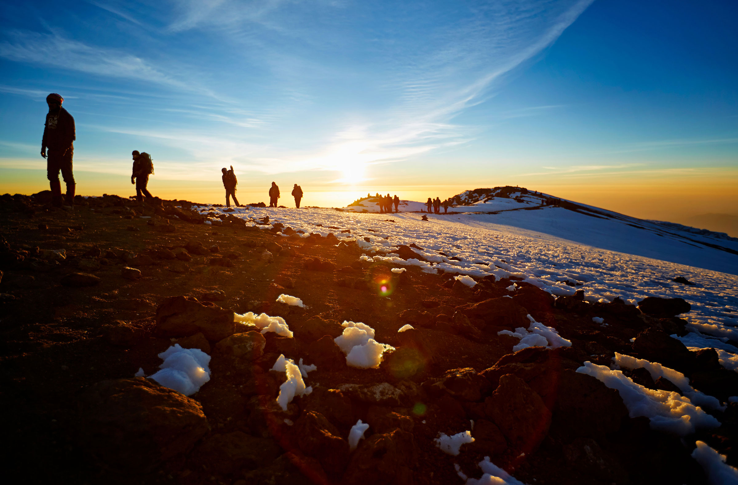 Snow-covered summit rising above a sea of clouds